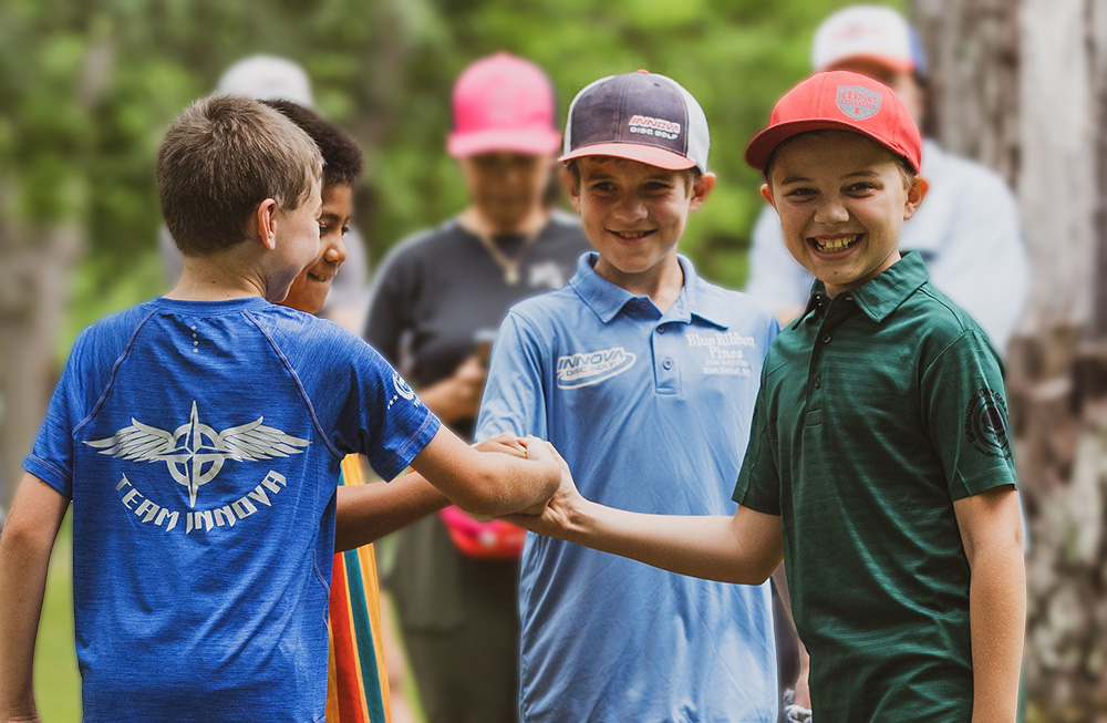 kids smiling and fist bumping