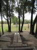 Hole 4 - Short position, looking back toward tee pads.  The position is on an 'island', in the trees, and also elevated on an old abandoned oil well.